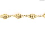 a close up of a gold bracelet on a white background