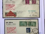 two envelopes with stamps on them are sitting on a table