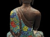 an image of a statue of a buddha sitting on top of a table
