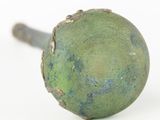 a close up of a green knob on a white surface