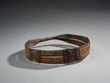 bracelet tissé marron orné de perles marron sur un fond blanc