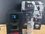 a coffee machine sitting on a table next to a box of coffee