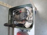 a green container with tools in it on the floor