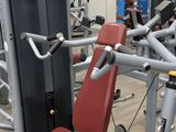 a gym room with a row of machines and other equipment