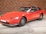 an image of a red sports car parked in a garage