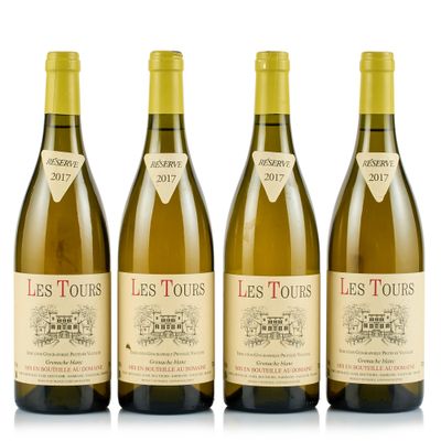 three bottles of white wine sitting next to each other on a white surface