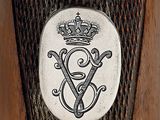 a close up of a metal object with a crown on it