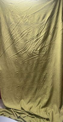 a blanket that is laying on a bed in a room