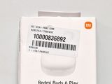 a box of redmi buds and play on the table