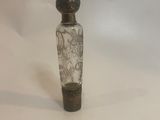 a small glass bottle with a black and white design on it