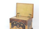 a small wooden box with a decorative design on it