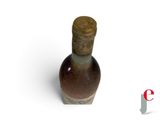 a small bottle with a cork on it on a white surface
