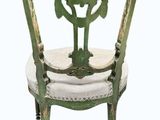 chair made of wood and painted in green with a white cushion