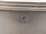 a close up of a silver plate with a hole in the middle