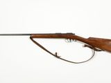a rifle on a white background with a gun in the foreground