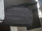 a bag that is sitting on a table next to a laptop