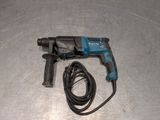 a cord connected to a drill on a metal surface