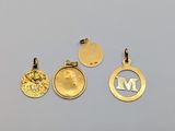 three gold pendants with the letter m on them