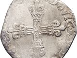 a close up of a coin with a cross on it