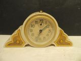 yellow and white clock sitting on top of a white table