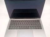 a close up of a laptop computer on a white surface