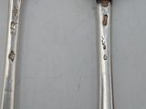 two spoons that are sitting next to each other on a table
