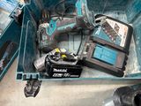 a blue box with tools inside of it on the floor