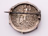 an old silver coin with a sword stuck in the middle of it