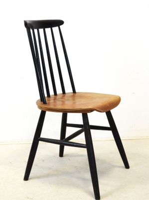 a wooden chair with black legs and a wooden seat