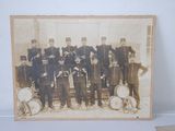 an old photo of a group of men in uniform posing for a picture