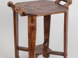 une vieille table d'appoint en bois avec un plateau et des pieds en bois
