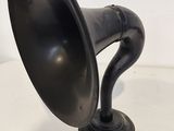 a black horn that is sitting on a white table