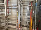 many different types of baseball bats in a garage