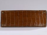 crocodile skin leather wallet with brass studs on the front