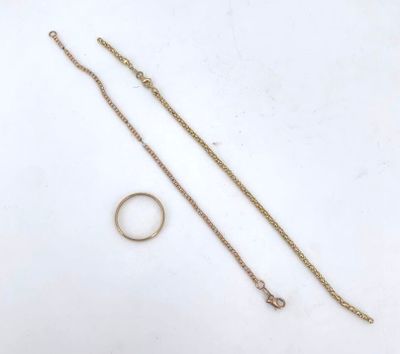 two rings and a gold chain on a white surface