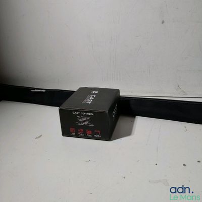 a black box sitting on the floor next to a white wall