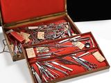 many pairs of scissors in a case on a table