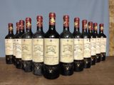 several bottles of wine are lined up in a row on a table