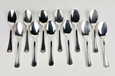 six spoons and six spoons sitting on a table