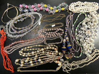 many different types of necklaces and bracelets on the table