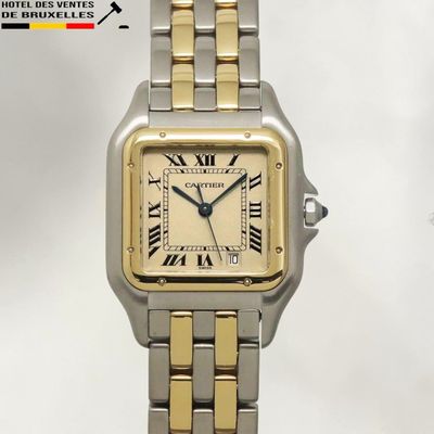 an image of a silver and gold watch with roman numerals