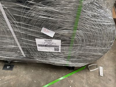 a large roll of wire wrapped in plastic on the ground