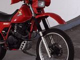 a red motorcycle that is parked in a garage