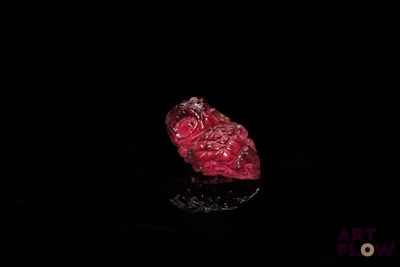 an image of a red piece of glass on a black surface