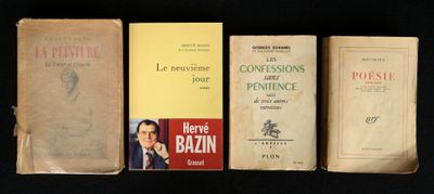 several old books are lined up on a black surface