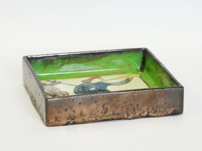 a small metal tray with a picture of a horse on it