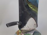 a vase that has a bird on top of it