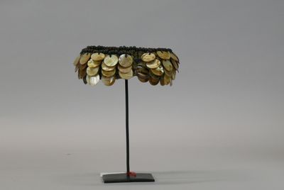 an image of a lamp with coins on it on a stand