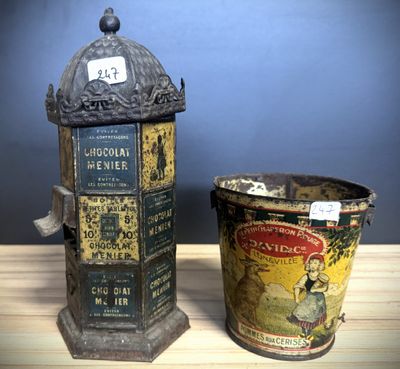 two tins of chocolate sitting next to each other on a wooden table