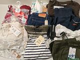 a lot of clothes and bags that are on a table